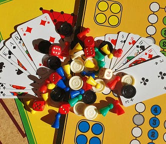cards and brightly colored game pieces on a yellow game board
