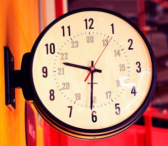 Analog clock mounted on a wall bracket reads 9:30.