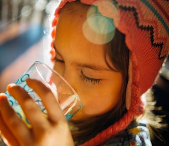 Little girl enjoying a glass of water