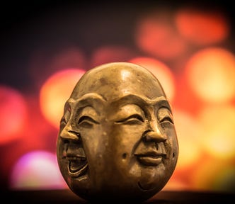 A statue with multiple faces of emotion