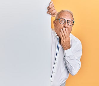 Surprised grandpa on gray and yellow background