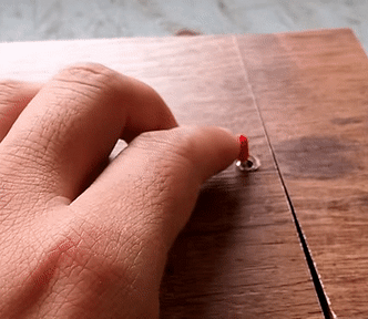 An animated gif depicting a ‘Useless Machine,’ that is, a box with a switch on it. When the operator’s finger flips the switch, a mechanical finger pops out of the box and flips it back and retracts back under the box lid. The loop shows the human and mechanical finger locked in an endless duel. Image: 陳韋邑 (modified) https://www.youtube.com/watch?v=PzlFOEJ1MiA CC BY 3.0: https://creativecommons.org/licenses/by/3.0/legalcode