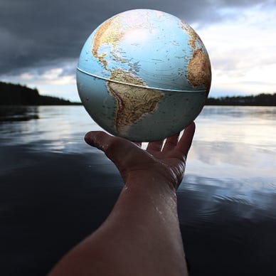 hand holding out globe