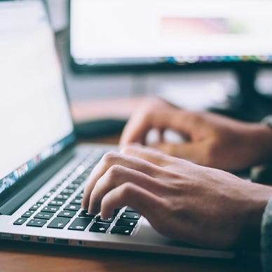 person typing on a laptop