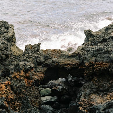 Water crashing against a rocky shoreline.