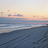 Brigantine Beach at sunset with waves and a variety of tracks in the sand.