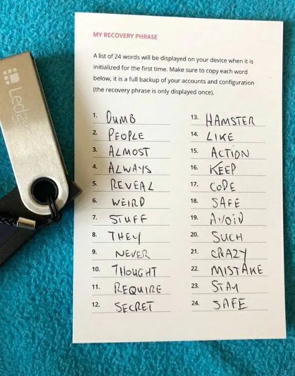 Illustration of the 24 recovery words being handwritten on the official Ledger recovery sheet