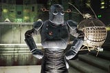 The Mechanist from Fallout 4 in costume, standing proudly beside an Eye-bot