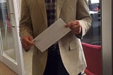 Man with a white envelope for “Resignations Suck” article