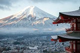 Mount Fuji in the background, red Japanese shrine in the foreground.