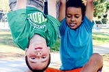 My son, right, with his friend hanging from the monkey bars.