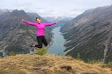 girl jumping with the backdrop of a valley