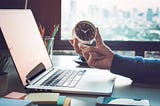 Business concepts with businessman holding clock on computer laptop.For investment analysis,Waiting to sucess ideas. Find a time.