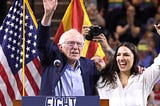 Bernie Sanders and Alexandria Ocasio Cortez speaking together at a “Fight the Oligarchs” rally