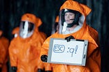 Amy Adams is holding a sign in an attempt to communicate with aliens in the film “Arrival”, but instead of showing the word “Human” it shows the command to exit Vim