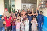 Educators and learners at Sadhoke Deaf Reach School making the “I love you” hand sign.