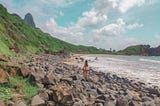 Standing over praia do meio in fernando de noronha, brazil