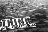 stenciled words “Think, it’s not illegal yet”