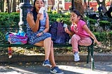A mother and her daughter eating a yummy ice cream in a public park in Mexico City
