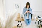 woman using her smartphone to check email (that’s what I’m saying she’s using the phone for)