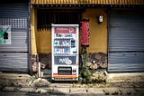 An old, abandoned Pokka Coffee vending machine in rural Japan.