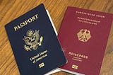 A german passport and an american passport on a wood background