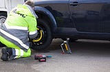 A man changing his flat tire