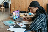 Designer working with paper drawings and a ditial Kanban Tool board