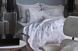 Alexandre Turpault Namaste duvet and sham collection in soft neutral tones.