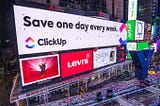 ClickUp Banner on a building — Save one day every week