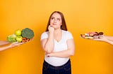 Young woman deciding whether to eat healthy or unhealthy food.