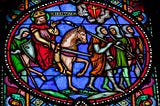 Photo of a stained-glass window that depicts a warrior wearing a crown and riding a horse along with four armored soldiers carrying spears and shields.