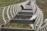 China: Man left dangling from bridge after glass breaks