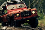 Old Land Rover ripping through mud in a forest. Photo courtesy of ahmed syahrir at Pexels.