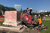 BREAKING: Angry Commonwealth protestors topple and deface statues of Queen Elizabeth and her great-great-grandmother Victoria