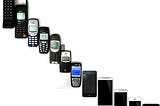 A series of mobile phones showing how their shape and form have changed over many versions.