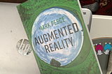 The cover of the book Augmented Reality, resting on a HP Laptop