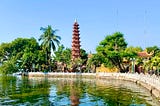 A sunny day in Hanoi, Vietnam near the lake with a historic pagoda in the background