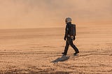 Astronaut walking on a desert-like landscape, similar to Mars