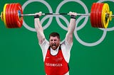 Olympic weightlifter Lasha Talakhadze lifting weights overhead.