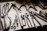 A set of old tools laying on a workbench
