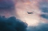 Airplane in the sky, surrounded by clouds.