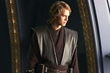 Anakin Skywalker stares out a window broodingly during Revenge of the Sith. With his long hair, facial scar, and dark clothing he is effectively being communicated as tainted by the dark even before he falls.