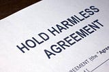 How does a hold harmless agreement work in business