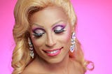 drag queen wearing glitzy long drop crystal clip on earrings