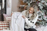 Mizzen+Main Shirts, the Perfect Gift for Him featured by top Orange County style blog, Dress Me Blonde: image of a woman opening a Christmas gift with a Mizzen+Main shirt