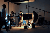 Several people working to set up a set for a video shoot