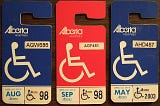 A series of three blue and red accessible parking placards from Alberta