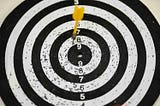 A target with a dart in the middle of it. Target audience research is much like this.