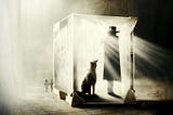 A large cat or dog is sitting behind a figure in a brimmed hat and long coat. They are both in a see through cube. The box of Schrödinger’s cat. Sepia tones but with light rays coming from the top left corner. The cat is watching the kids from the logo walk away.